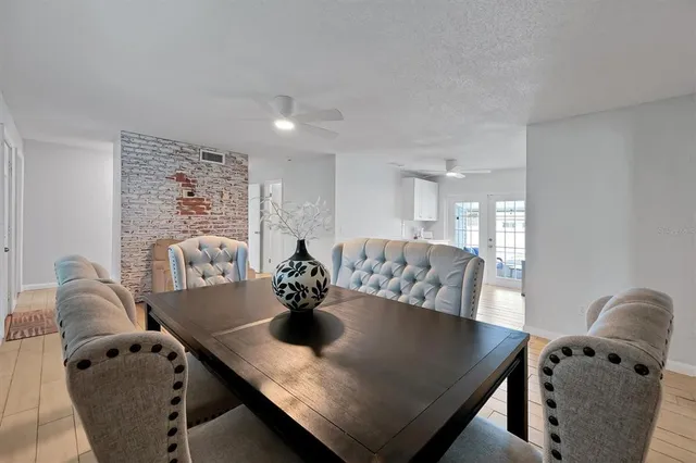 a view of a dining room and hall with furniture
