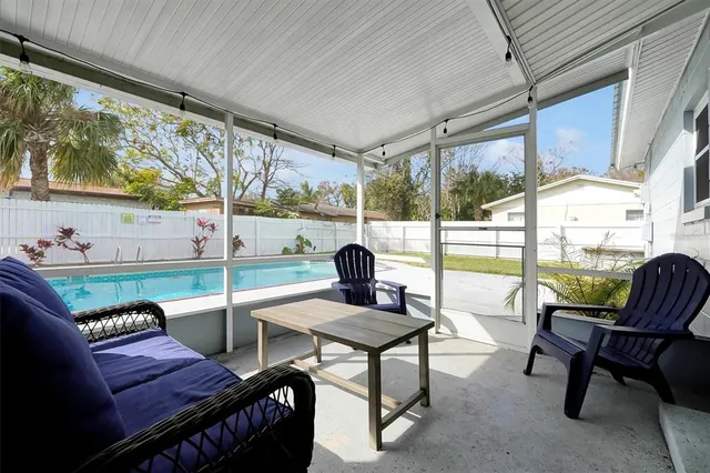 a living room with furniture and a floor to ceiling window