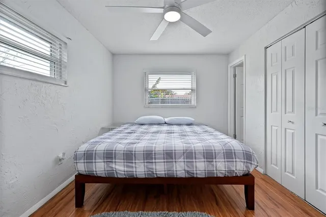 a bedroom with a bed and a window