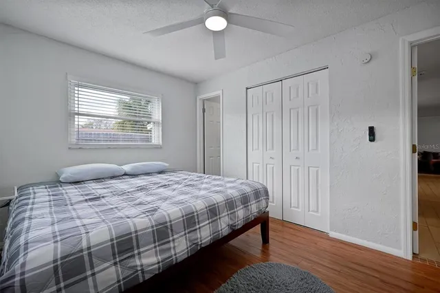 a bedroom with a bed and a window