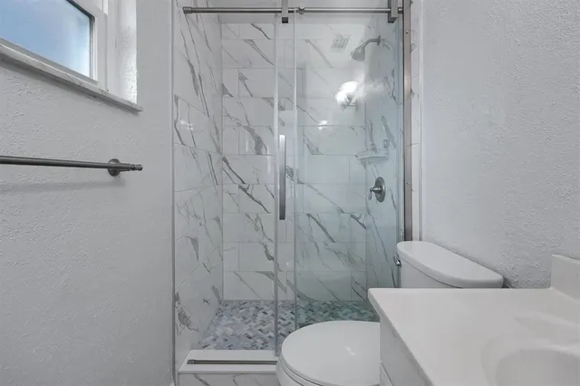 a bathroom with a toilet and shower