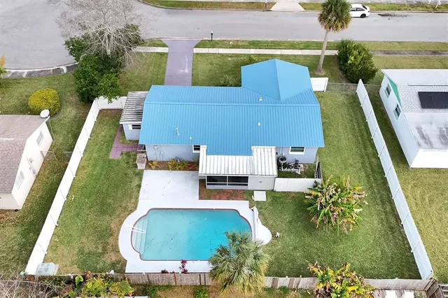 an aerial view of a house with a yard and lake view