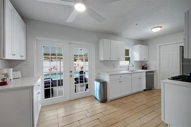 a kitchen with a sink stove and cabinets