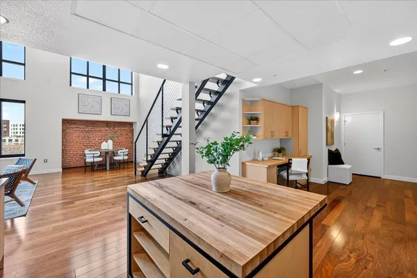 a room with table chairs and wooden floor