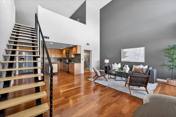 a living room with furniture and wooden floor