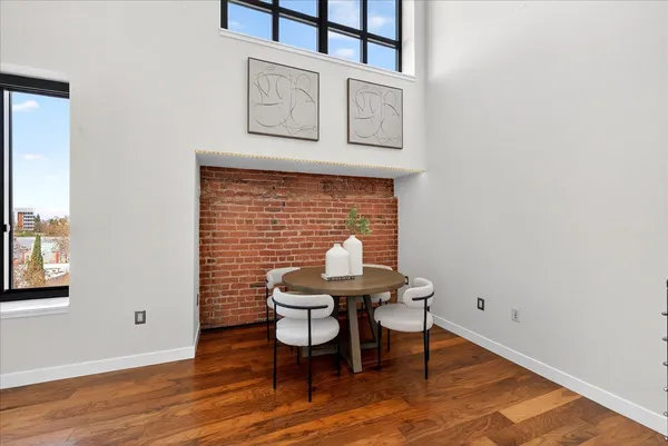 a brick wall with a chair and potted plant on top of it