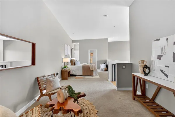 a bedroom with furniture and a wooden floor