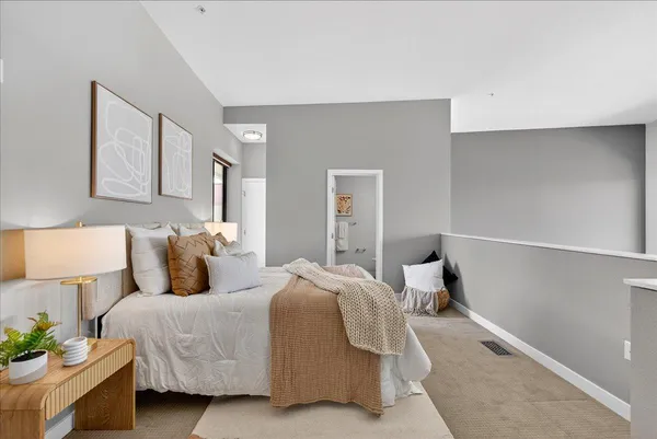 a bedroom with a bed and a lamp