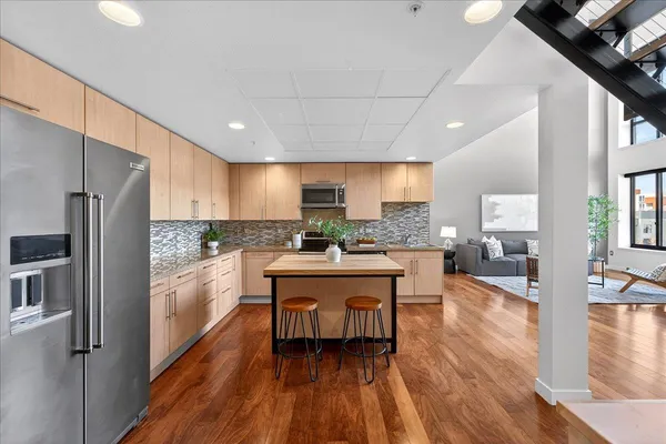 a kitchen with a sink appliances and cabinets
