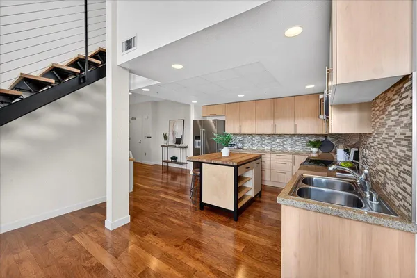 a kitchen with a sink and a stove top oven