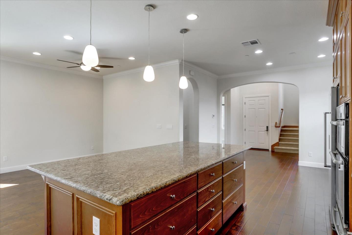 1345 Bayberry View Lane San Ramon, CA 94582 - Photo 13 of 65 an empty room with wooden floor and a ceiling fan
