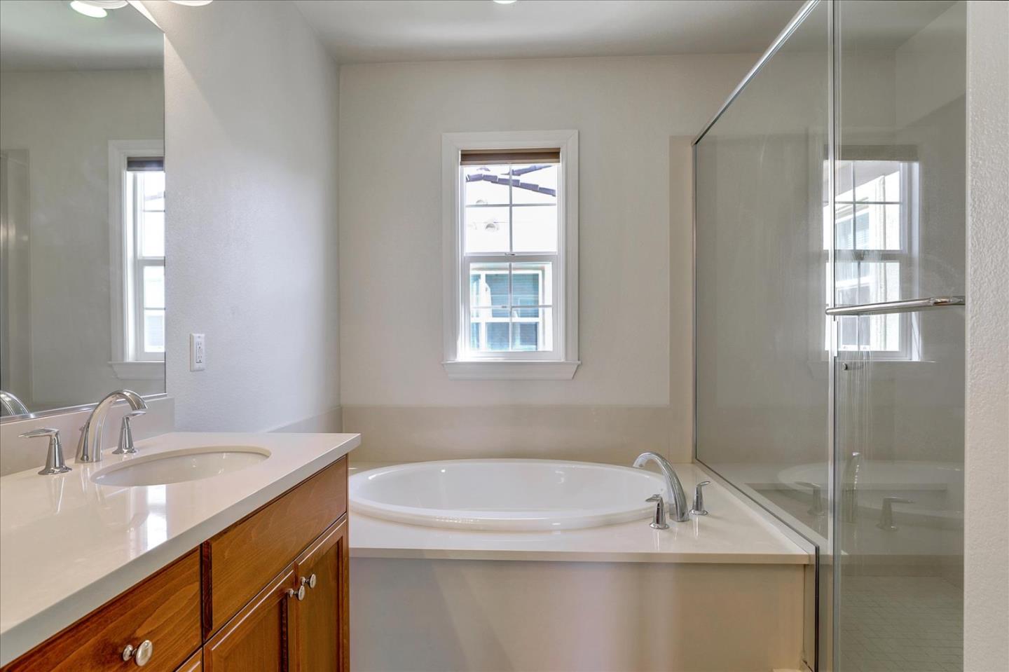 1345 Bayberry View Lane San Ramon, CA 94582 - Photo 45 of 65 a bathroom with a granite countertop sink a bathtub and window