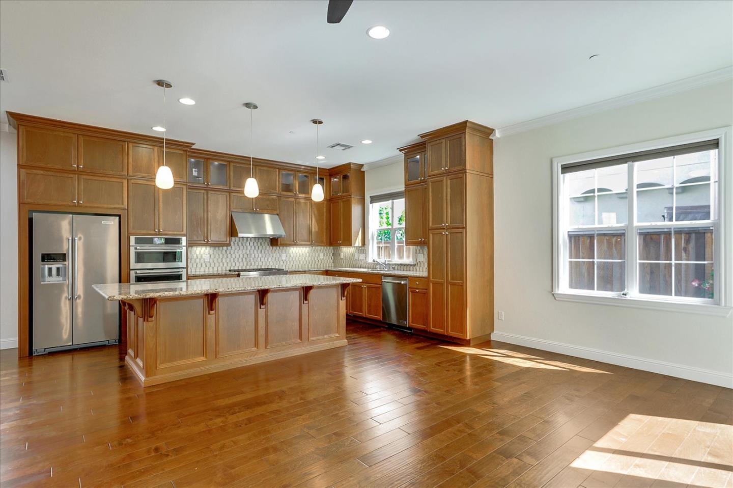 1345 Bayberry View Lane San Ramon, CA 94582 - Photo 8 of 65 a large kitchen with a large counter top a sink stainless steel appliances and cabinets