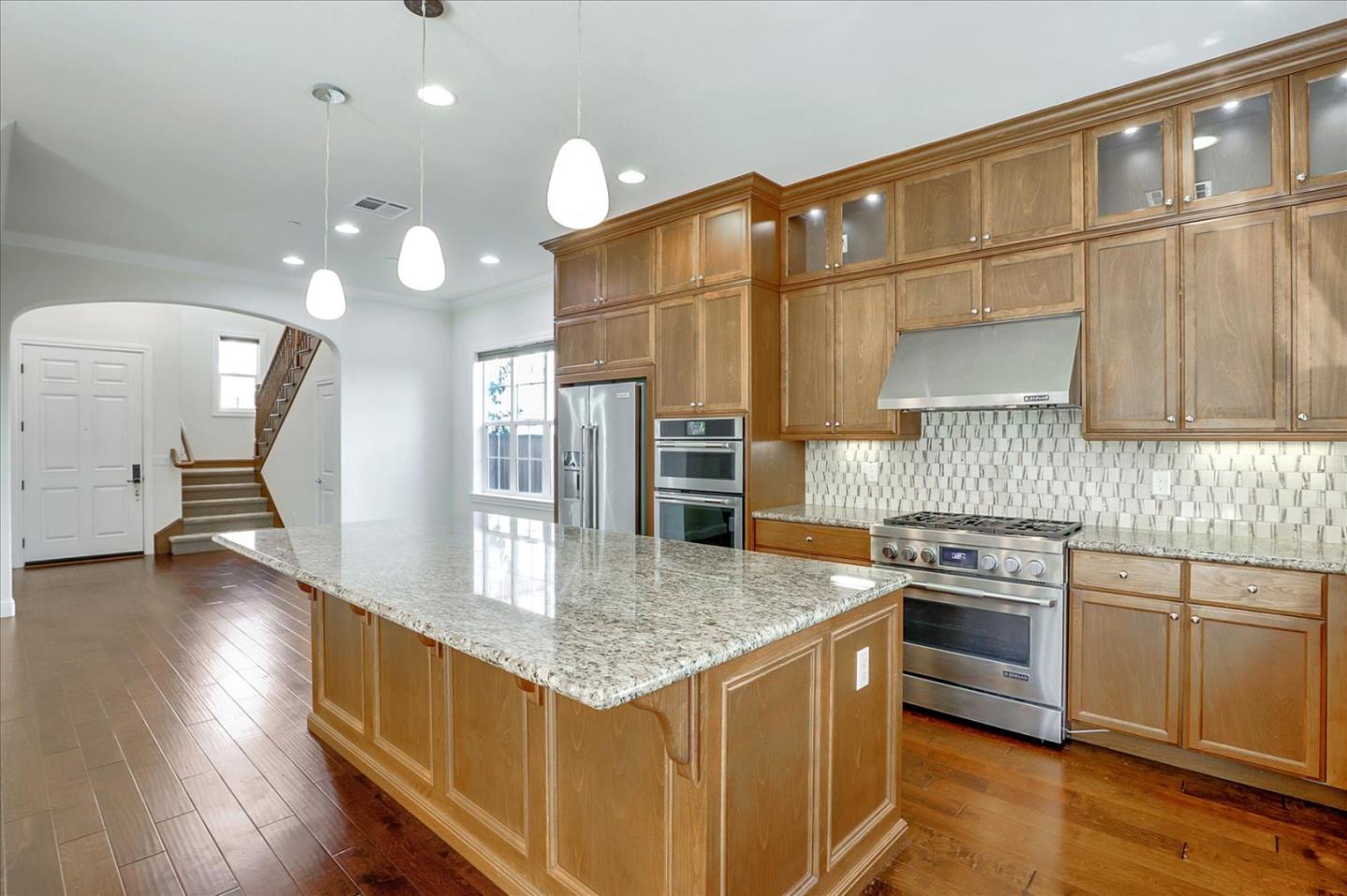1345 Bayberry View Lane San Ramon, CA 94582 - Photo 9 of 65 a kitchen with stainless steel appliances granite countertop a sink a stove and a wooden floors