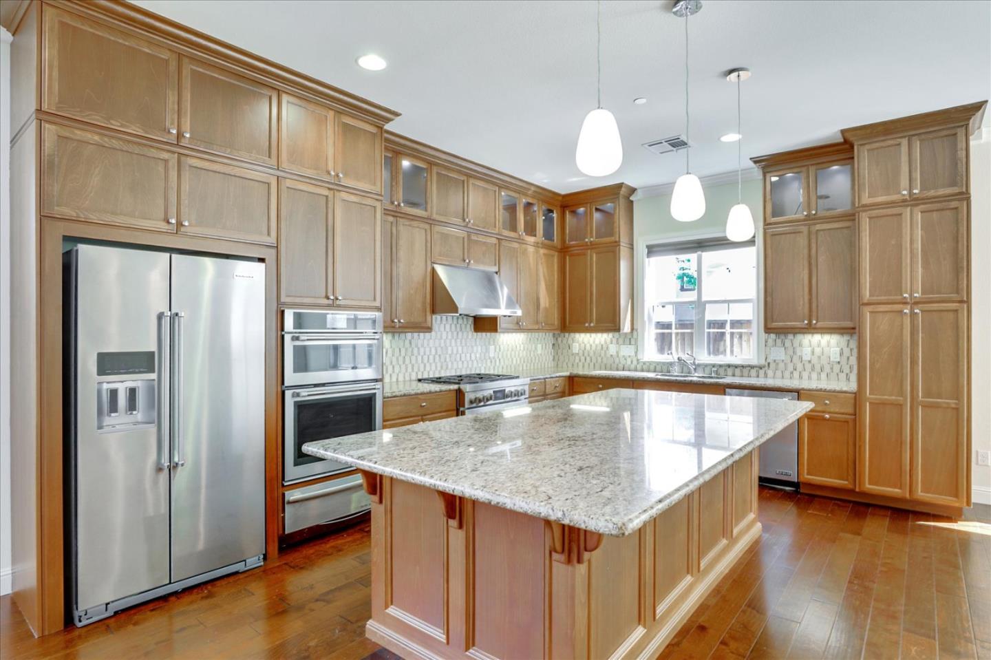1345 Bayberry View Lane San Ramon, CA 94582 - Photo 10 of 65 a kitchen with kitchen island granite countertop a sink a center island and stainless steel appliances