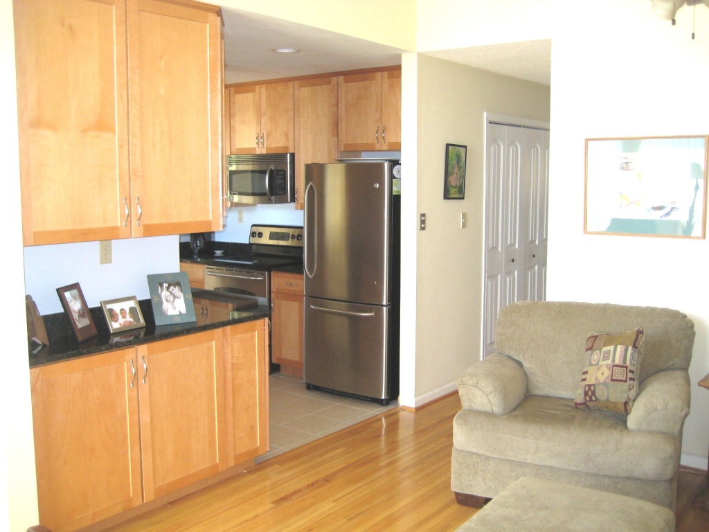 908 Skyview Road Salem, VA 24153 - Photo 8 of 21 a kitchen with granite countertop a refrigerator a stove a sink and white cabinets with wooden floor