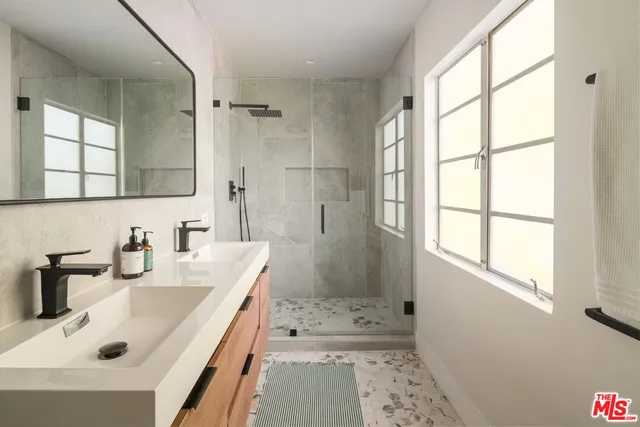 a bathroom with a sink a shower and a bathtub