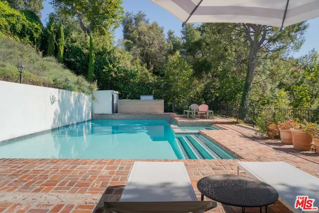 swimming pool view with a seating space