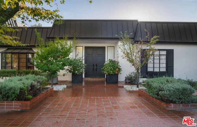 a front view of a house with garden