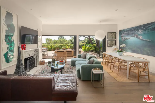 a living room with fireplace furniture and a flat screen tv