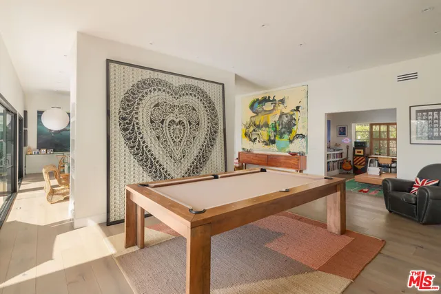 a living room with a table and chairs