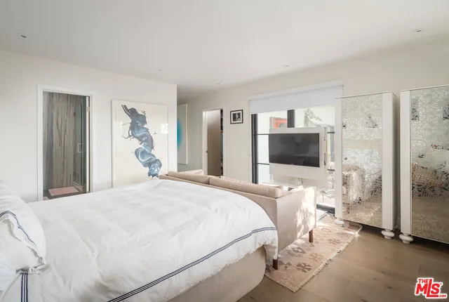 a bedroom with a bed and a television