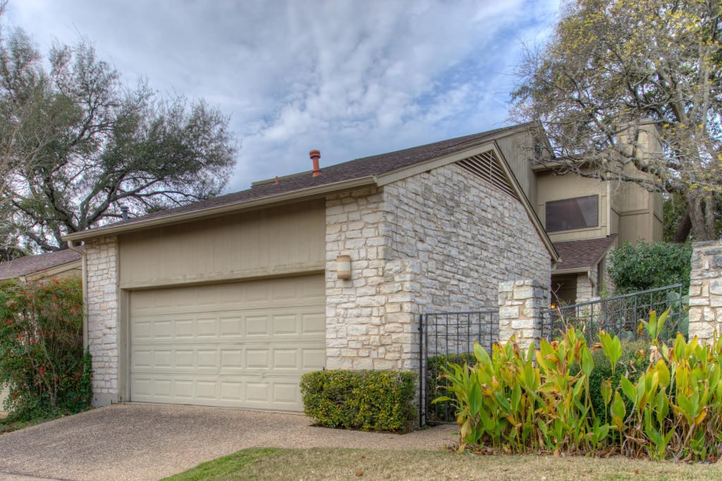 8018 Raintree Place Austin, TX 78759 - Photo 1 of 1 a front view of a house with a yard