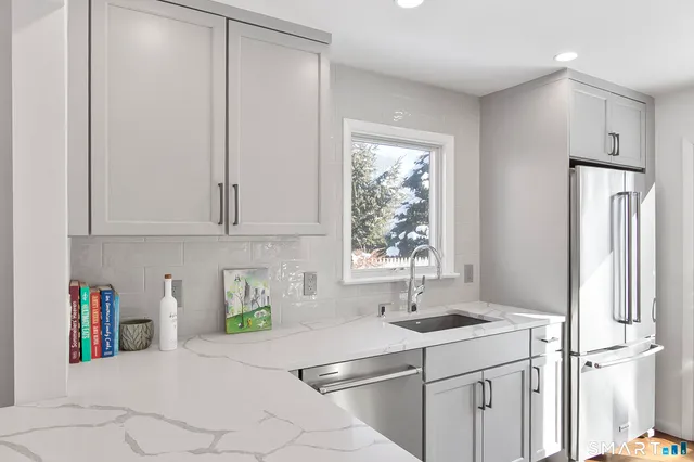 a kitchen with stainless steel appliances a stove a sink and a microwave