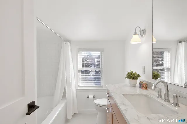 a bedroom with a bed and a night stand