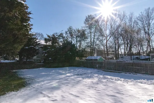 a view of staircase with white walls and railing
