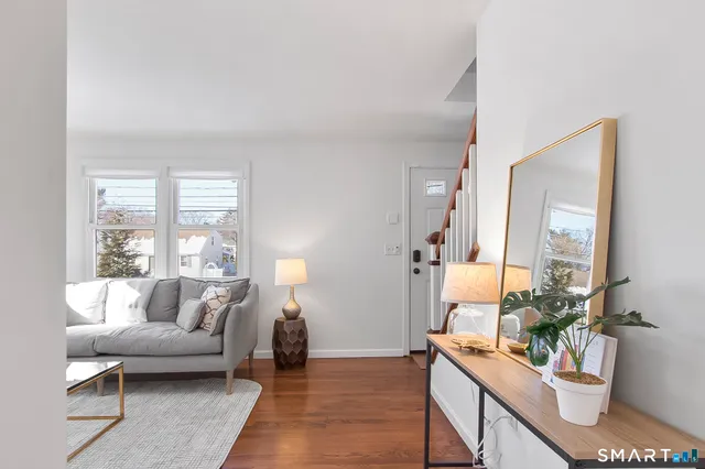 a living room with furniture and wooden floor