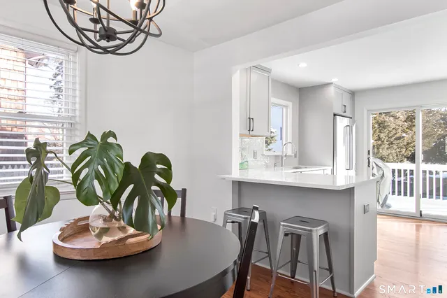 a view of a dining room with furniture wooden floor and a chandelier