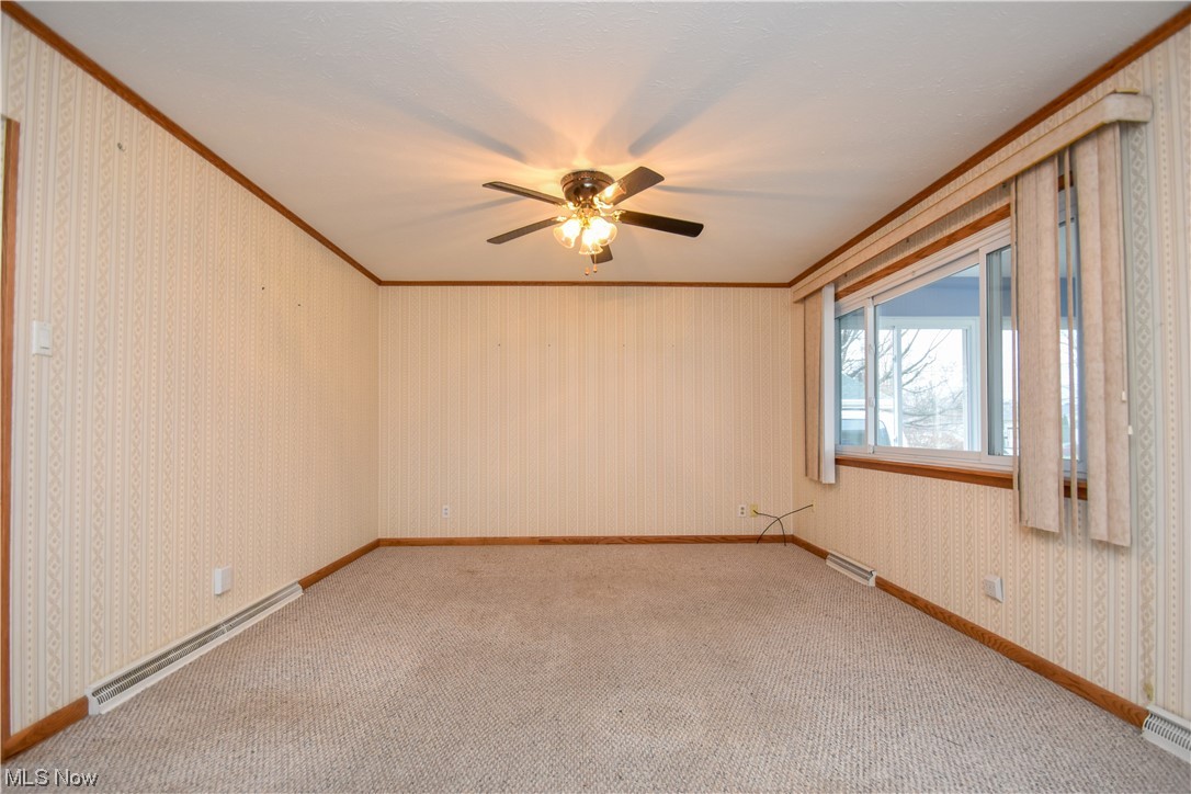 4606 Burkey Road Youngstown, OH 44515 - Photo 9 of 49 Carpeted empty room with ornamental molding, ceiling fan, and a baseboard radiator
