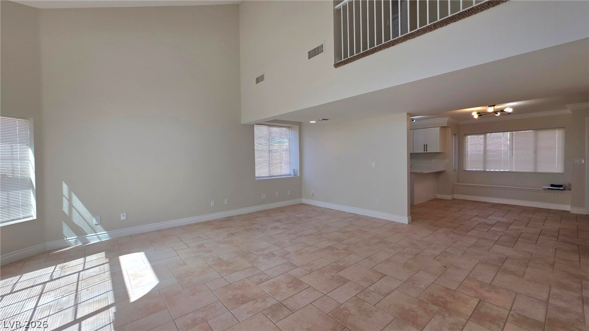 2155 Athol Way Laughlin, NV 89029 - Photo 6 of 19 A spacious living area features high ceilings and durable tiled flooring, leading to an inviting dining nook.