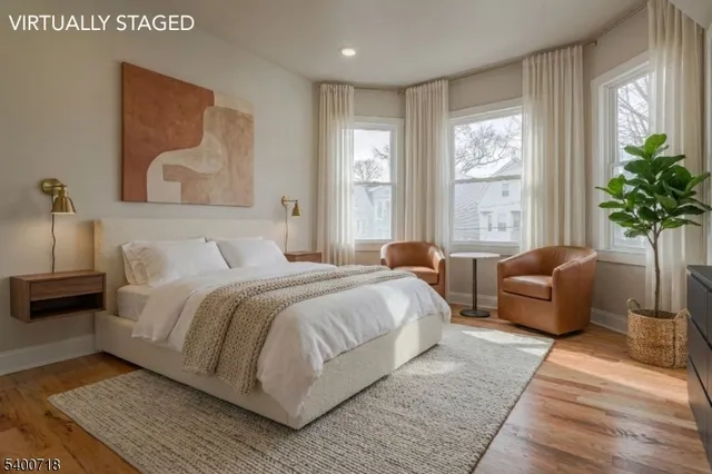 a bedroom with a large bed couch and a window