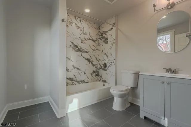 a bathroom with a toilet and a shower curtain