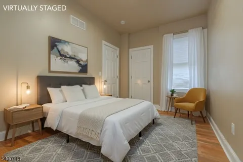 a bedroom with a bed and a couch