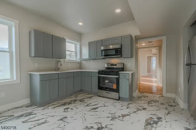 a kitchen with a refrigerator stove and sink