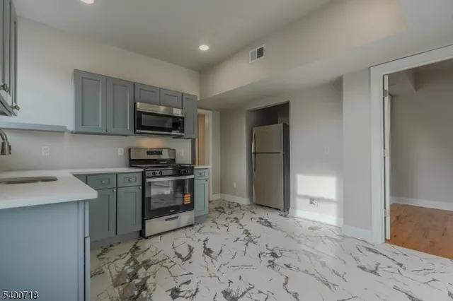 a kitchen with a refrigerator stove and sink