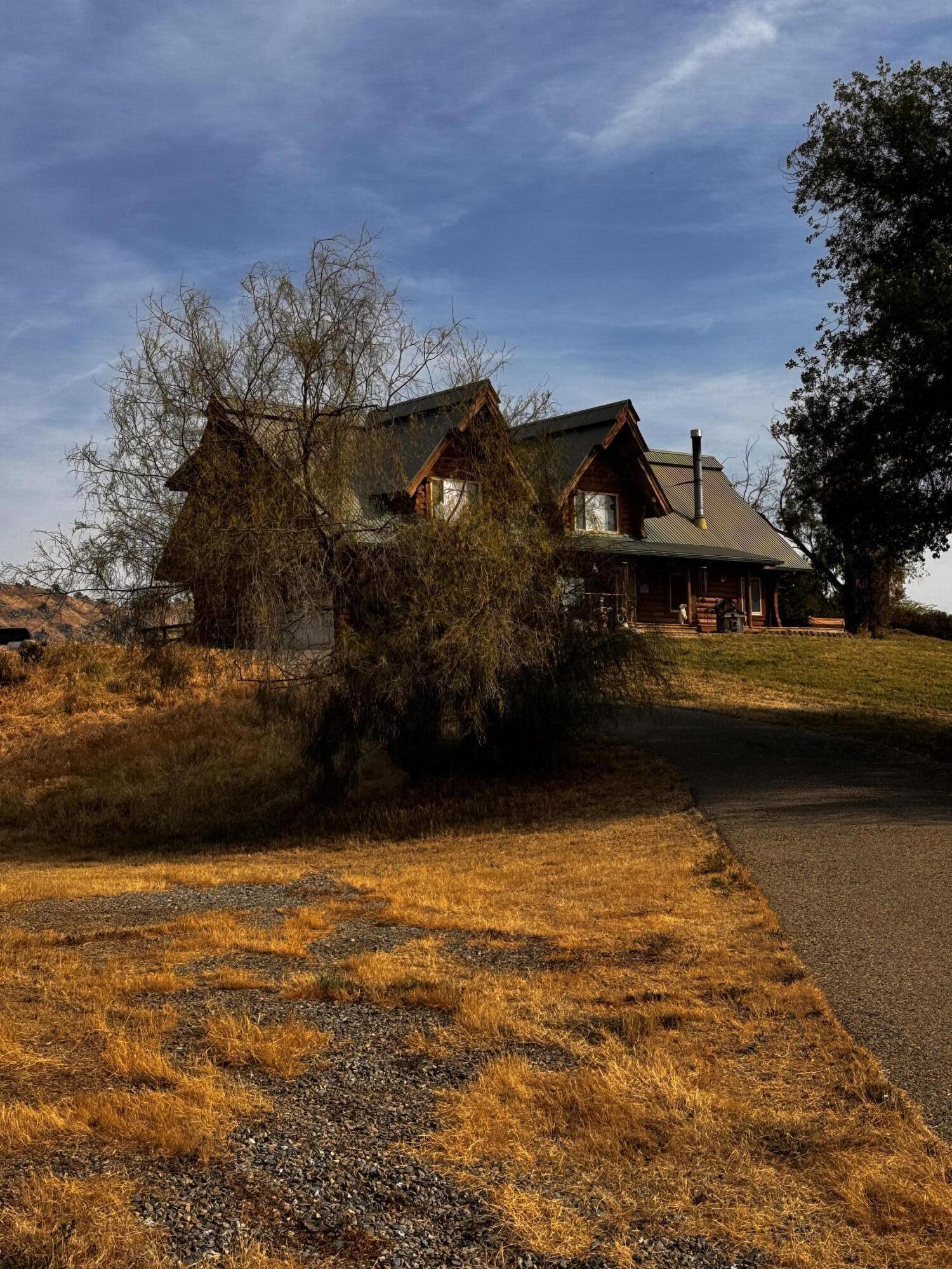 30723 Hamilton Drive Exeter, CA 93221 - Photo 7 of 85 a view of a lake with a house in the background