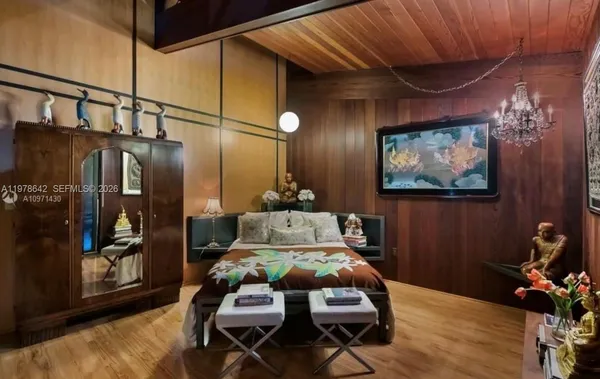 a living room with furniture a rug and white walls