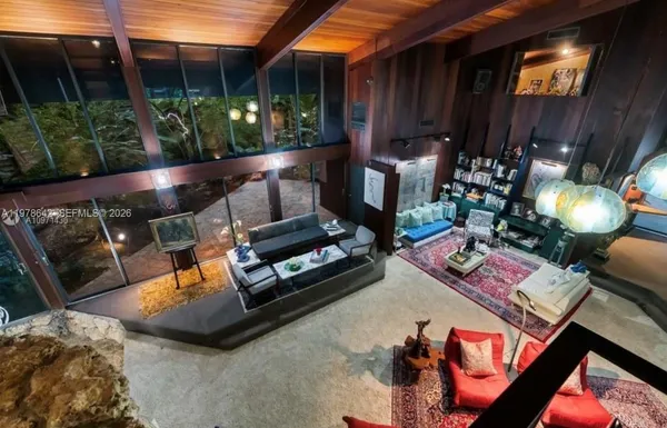 a view of a chairs and table in backyard