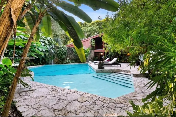 a view of a park with plants and a bench