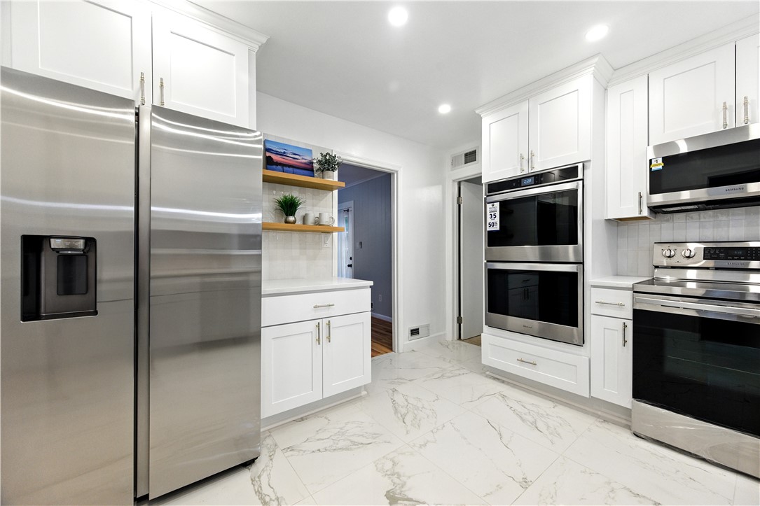 111 Braddock Road Williamsburg, VA 23185 - Photo 10 of 43 Kitchen with appliances with stainless steel finishes, white cabinets, recessed lighting, decorative backsplash, and open shelves