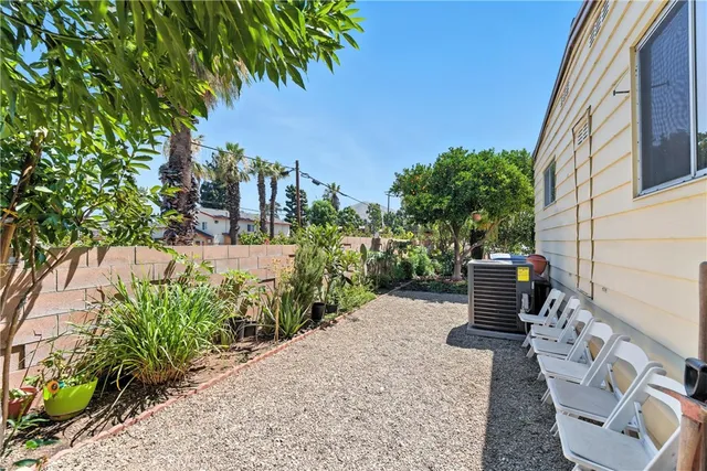 a view of a patio with table and chairs and potted plants