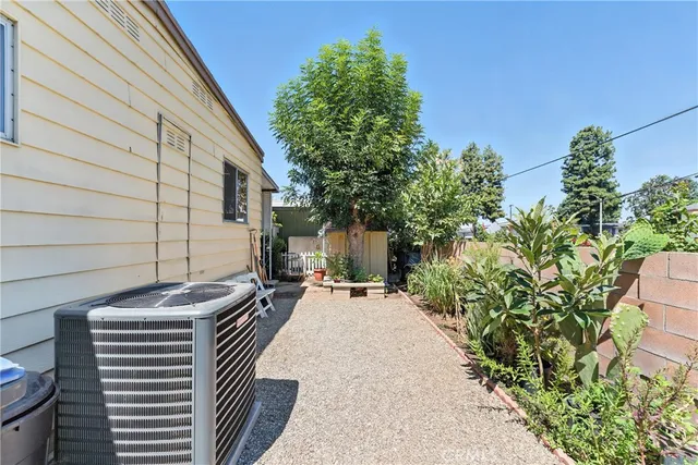 a view of a patio with table and chairs and potted plants