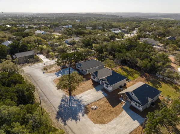 an aerial view of residential houses with outdoor space