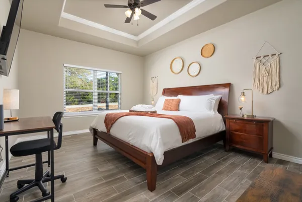 a bedroom with a bed and a chandelier