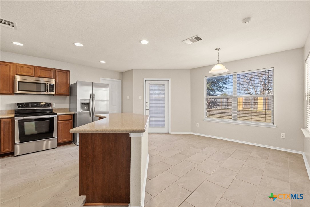 8420 Starview Street Temple, TX 76502 - Photo 13 of 36 a kitchen with stainless steel appliances granite countertop a stove and a sink