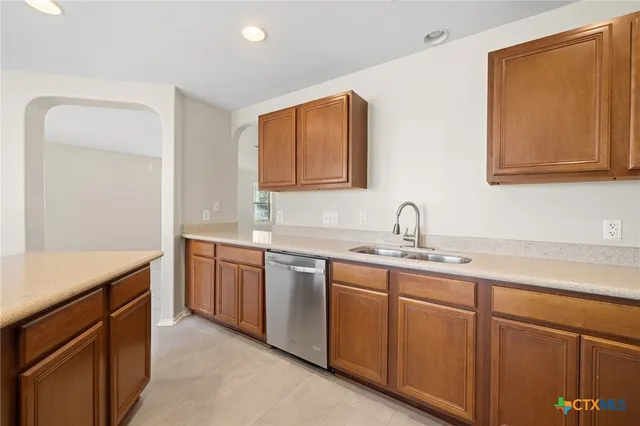 a kitchen with sink and cabinets